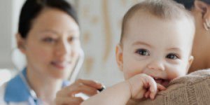 happy-and-smiling-baby-being-examined-by-a-doctor